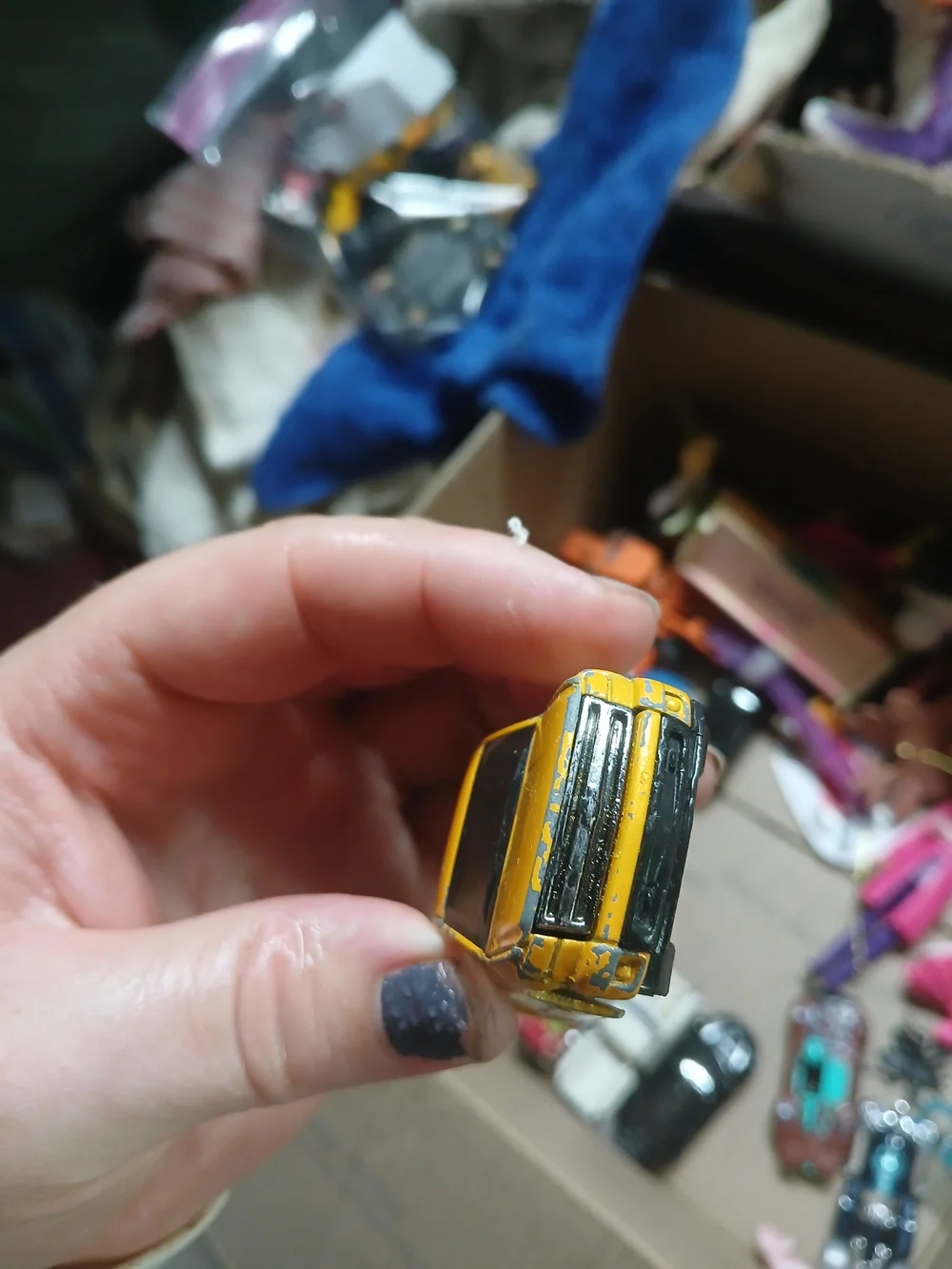 yellow 1:64 scale Hot Wheels Chevy Silverado,